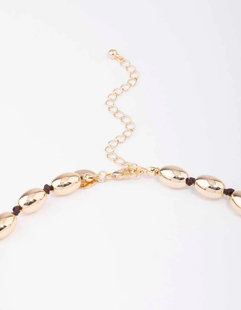 Gold Oval Bead Graduating Cord Necklace