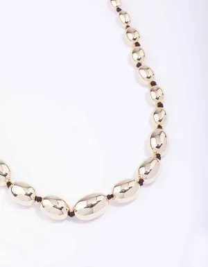 Gold Oval Bead Graduating Cord Necklace